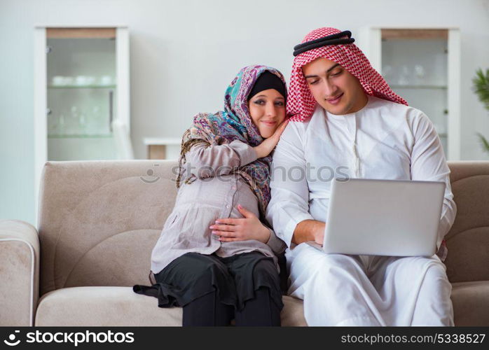 Young arab muslim family with pregnant wife expecting baby