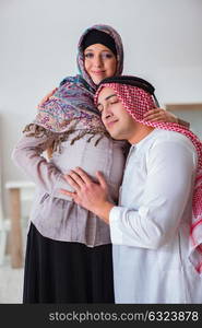 Young arab muslim family with pregnant wife expecting baby