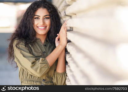 Young Arab Woman with curly hair smiling outdoors. Young Arab Woman with curly hair outdoors