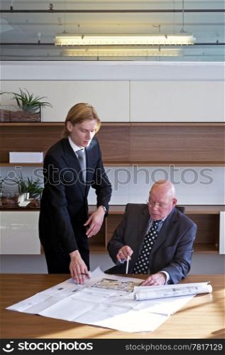 Young architect asking his boss to validate his designs