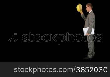 Young architect taking notes on a clipboard, walk in, against black