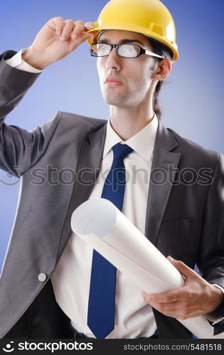 Young architect with drawings and hardhat