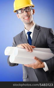 Young architect with drawings and hardhat