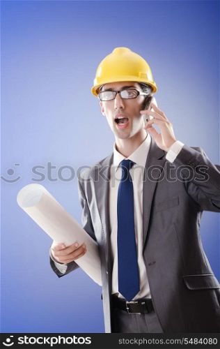 Young architect with drawings and hardhat
