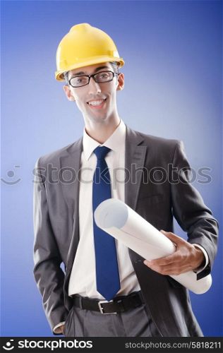 Young architect with drawings and hardhat