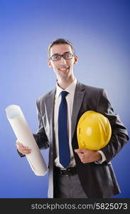 Young architect with drawings and hardhat