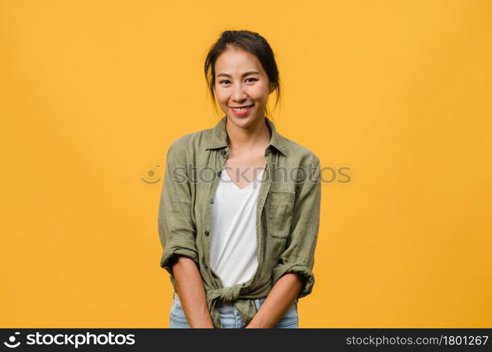 Young Asia lady with positive expression, smile broadly, dressed in casual clothing and looking at camera over yellow background. Happy adorable glad woman rejoices success. Facial expression concept.