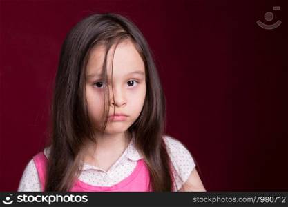 Young Asian American girl looking unhappy
