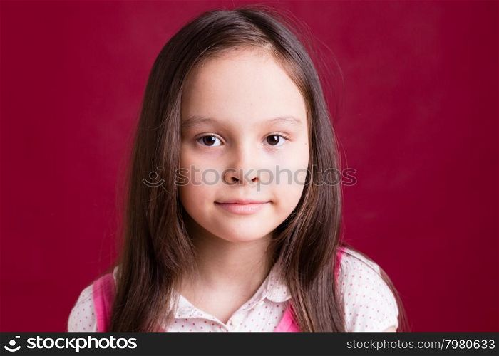 Young Asian American girl on red background
