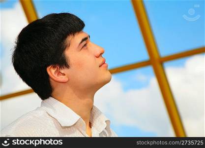 young asian boy looks to sky