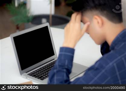 Young asian business man headache during working on laptop computer display blank screen with deadline at home, businessman with failure exhausted, stress and worried, frustrated and unsuccessful.