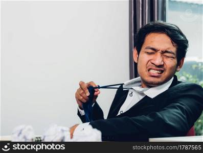Young asian business man manager frustrated he has tired after work long time