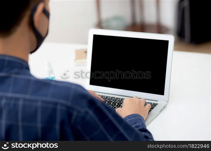 Young asian business man using laptop computer blank screen mockup for video call online and communicate work from home, male conference with notebook, social distancing, communication concept.