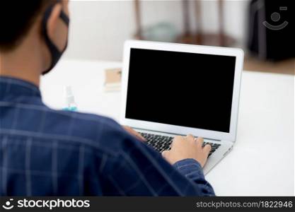 Young asian business man using laptop computer blank screen mockup for video call online and communicate work from home, male conference with notebook, social distancing, communication concept.