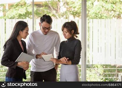 young asian business people ,man and woman, working with team in startup office