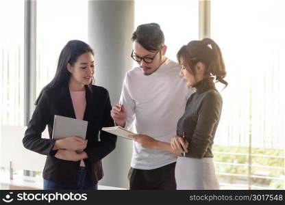 young asian business people, man and woman, working with team meeting in startup office