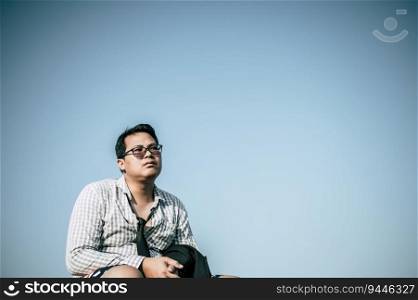 Young Asian Businessman wearing shirt and tie with shorts and eyeglasses with problems and stress or disappointment of work at outside corporate office, copy space
