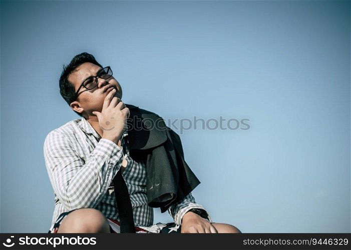 Young Asian Businessman wearing shirt and tie with shorts and eyeglasses with problems and stress or disappointment of work at outside corporate office
