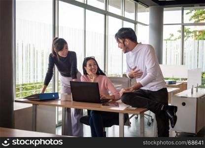 young asian businessman working with team in startup office