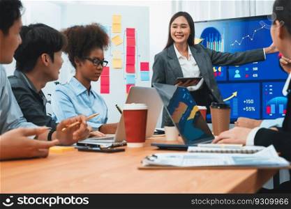 Young asian businesswoman presenting data analysis dashboard on TV screen in modern meeting. Business presentation with group of business people in conference room. Concord. Young asian businesswoman presenting data analysis dashboard on TV. Concord