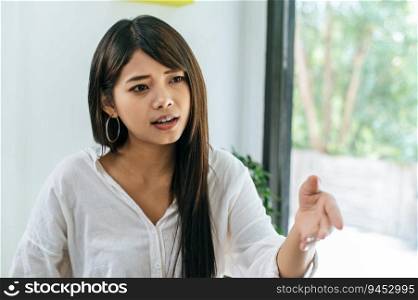 Young asian businesswoman shaking hands as close a deal or partnership at coffee shop, copy space