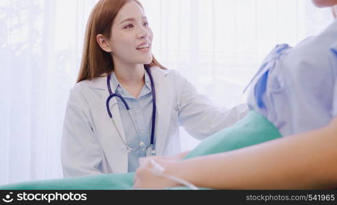 Young Asian doctor woman talking and holding hand for women patient in sick bed. Medicine, age, healthcare, psychiatrist and people concept.