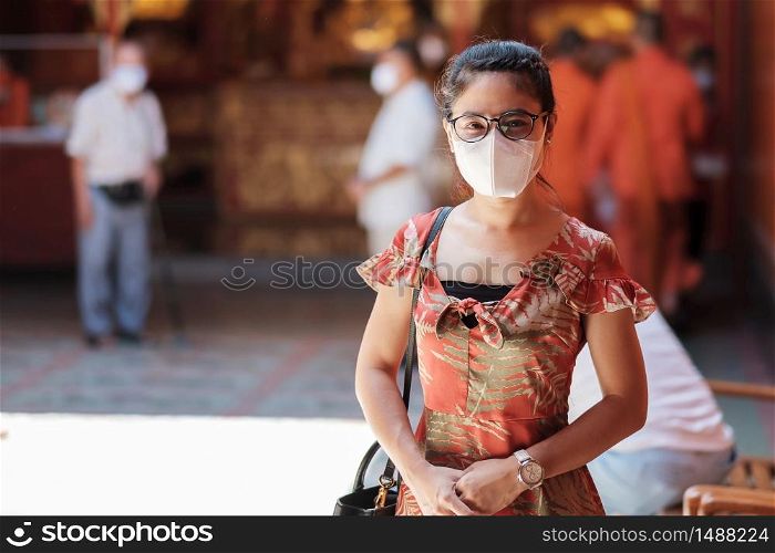 young Asian girl wearing Protective face mask protect coronavirus inflection, Happy tourist woman in New Normal lifestyle after covid-19 pandemic