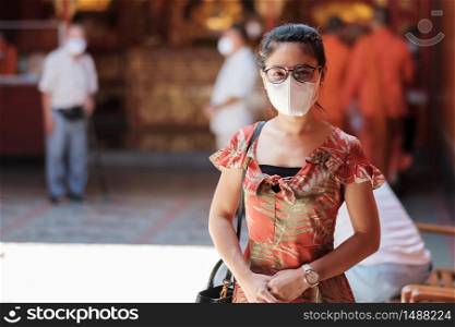 young Asian girl wearing Protective face mask protect coronavirus inflection, Happy tourist woman in New Normal lifestyle after covid-19 pandemic
