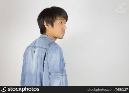 Young Asian Man in Jeans Jacket or Denim Jacket in Turn around Pose. Denim or Jeans Jacket Men Fashion on Gray Background