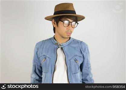 Young Asian Man in Jeans Jacket or Denim Jacket Wear Eyeglasses and Hat. Denim or Jeans Jacket Men Fashion on Gray Background