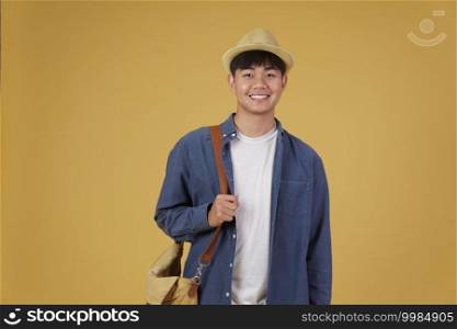 young asian man traveler smiling isolated on yellow background. Travel journey trip in holiday vacation