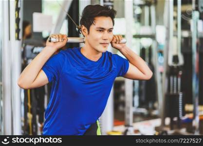 Young Asian man wearing sportswear doing excecise with the bar in gym fitness sport complex, posture position, sport club community, sports and healthcare concept,