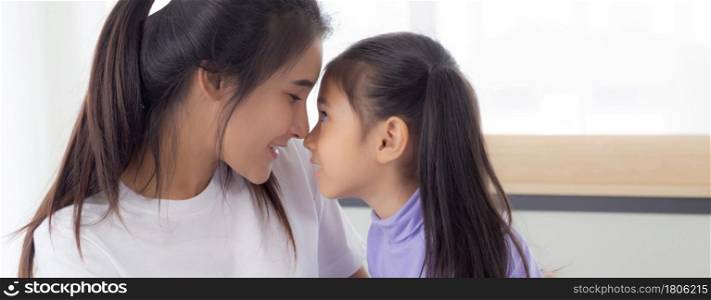 Young asian mother and daughter hug and touching nose on face with tender together, mom and girl with happy for relationship and bonding, feeling and emotion, parent and child, family concept.