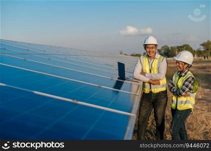 Young Asian technician engineer man and Female supervisor in white helmet, They are discussing quality of mounting of panels on laptop computer in solar farm, copy space