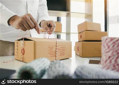 Young asian teenage product owners are packing small business packaging products in boxes prepared for shipping.