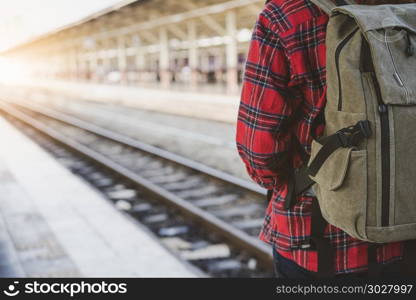 Young Asian woman backpacker traveler walking alone at train sta. Young Asian woman backpacker traveler walking alone at train station platform with backpack. Asian woman waiting train at train station for travel. Summer holiday traveling or young tourist concept.