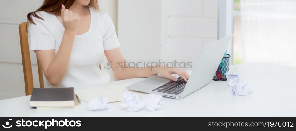 Young asian woman confident working at home with laptop computer and thinking idea for planning, freelance happy girl expression with excited and success using notebook thought, business concept.