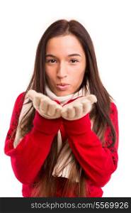 Young asian woman dressed for winter blowing a kiss or a new years wish