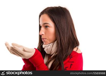 Young asian woman dressed for winter blowing a kiss or a new years wish