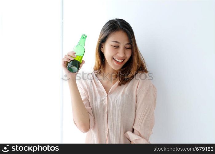 Young asian woman drinking beer at party, celebration, people and lifestyle