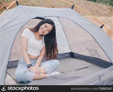 Young asian woman enjoy camping.