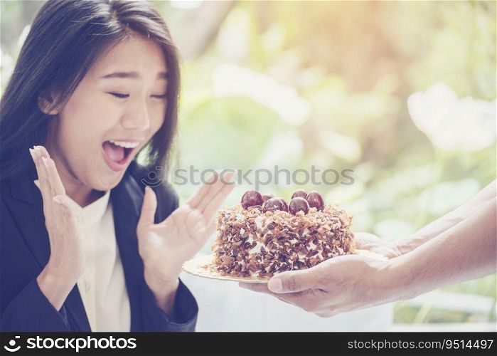 Young Asian woman face got a surprise cake on her birthday. feeling excite and happy.