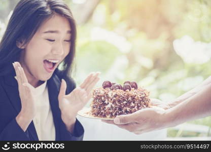 Young Asian woman face got a surprise cake on her birthday. feeling excite and happy.