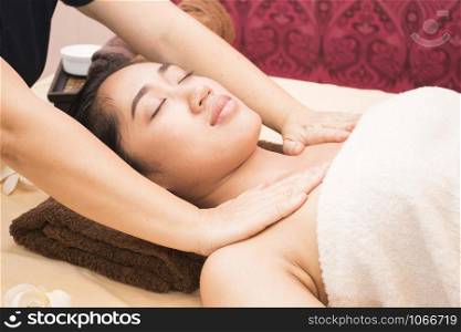 Young asian woman getting thai massage in spa