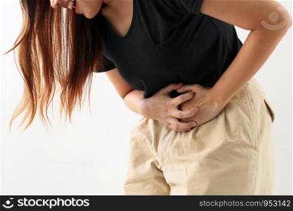 Young asian woman having pain in stomachache, stomach gas, food poisoning, indigestion, body sickness cancer concept.