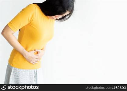 Young asian woman having painful stomachache on white background.Chronic gastritis. Abdomen bloating concept.