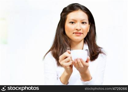 Young asian woman in casual. Image of young asian woman in casual wear holding a cup