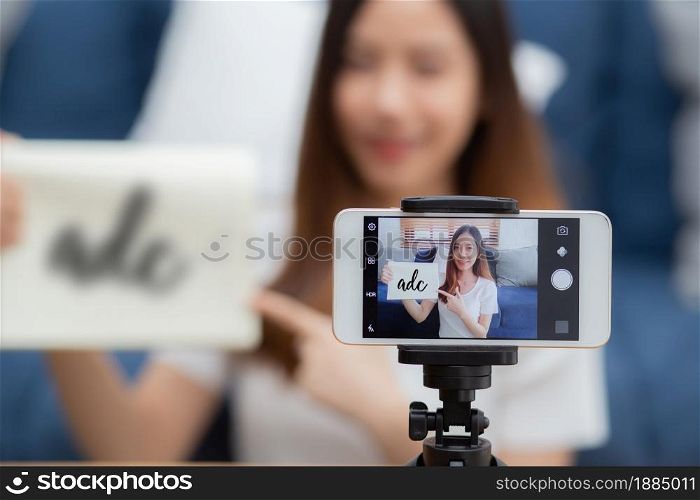 Young asian woman is teacher teaching language english with student for e-learning online at home, girl working and talking lesson in class with smartphone, stay home, new normal, education concept.
