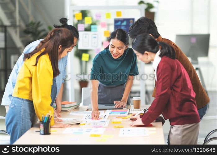 Young Asian woman leading business creative team in mobile application software design project. Brainstorm meeting, work together, internet technology, girl power, office coworker teamwork concept