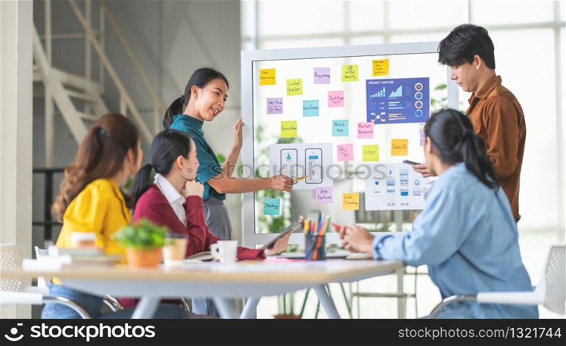 Young Asian woman leading business creative team in mobile application software design project. Brainstorm meeting, work together, internet technology, girl power, office coworker teamwork concept